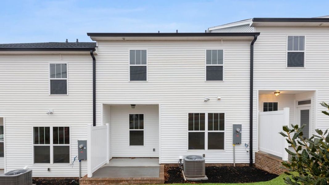 Exterior details and patio area of a home in Pearson Road Townhomes, Easley (Image 3).