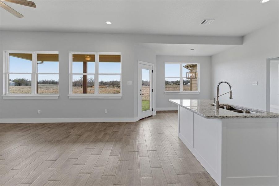 Open-concept living area connecting the living room, kitchen, and dining space. Open-concept living area connecting the living room, kitchen, and dining space.