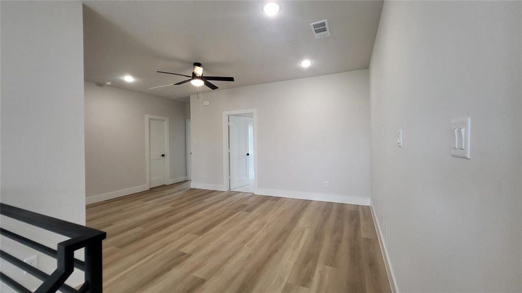 Unfurnished room with a ceiling fan, light wood-type flooring, baseboards, visible vents, and recessed lighting