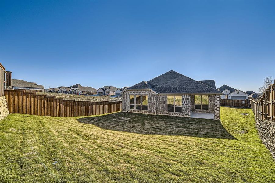 Back of property featuring a yard and a patio