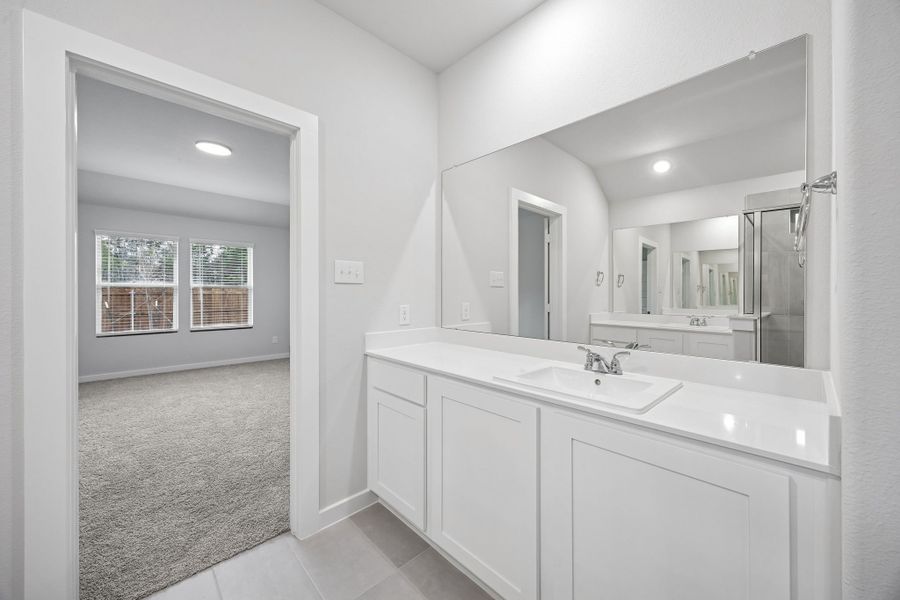 Primary Bathroom in the Heisman home plan by Trophy Signature Homes – REPRESENTATIVE PHOTO