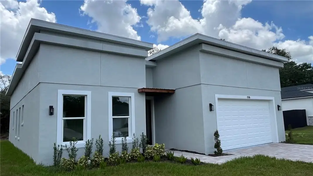Front exterior of a new home in , Ocala, FL, highlighting curb appeal (Image 1).