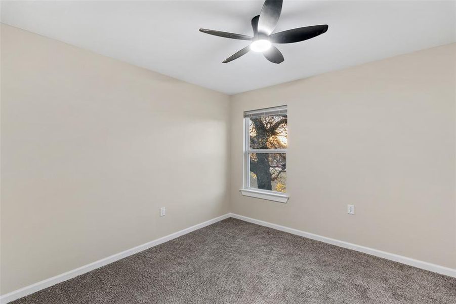 Spare room with carpet flooring and ceiling fan