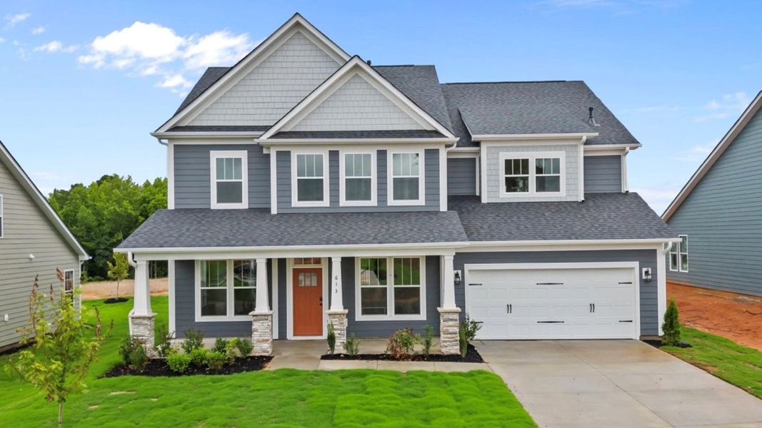 Front exterior of a new home in Pinebrook, Woodruff, SC, highlighting curb appeal (Image 2). Front exterior of a new home in Pinebrook, Woodruff, SC, highlighting curb appeal (Image 2).