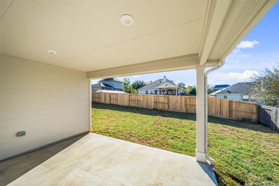 Sizable covered back patio overlooking back yard.