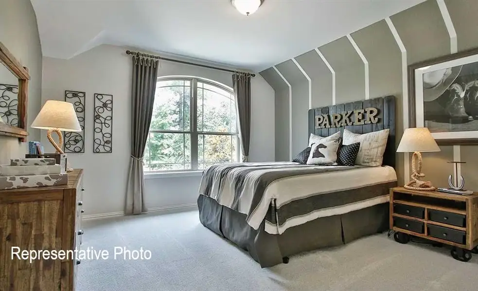 Carpeted bedroom featuring lofted ceiling