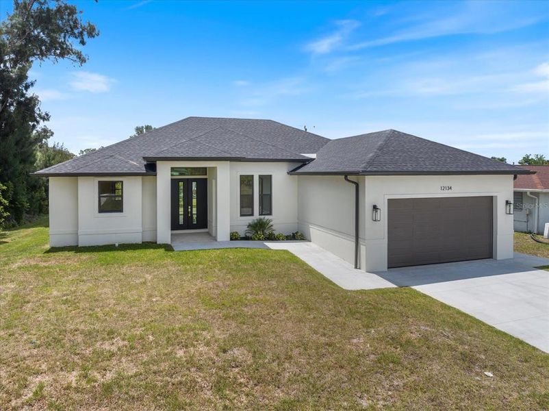 Front exterior of a new home in , North Port, FL, highlighting curb appeal (Image 19). Front exterior of a new home in , North Port, FL, highlighting curb appeal (Image 19).