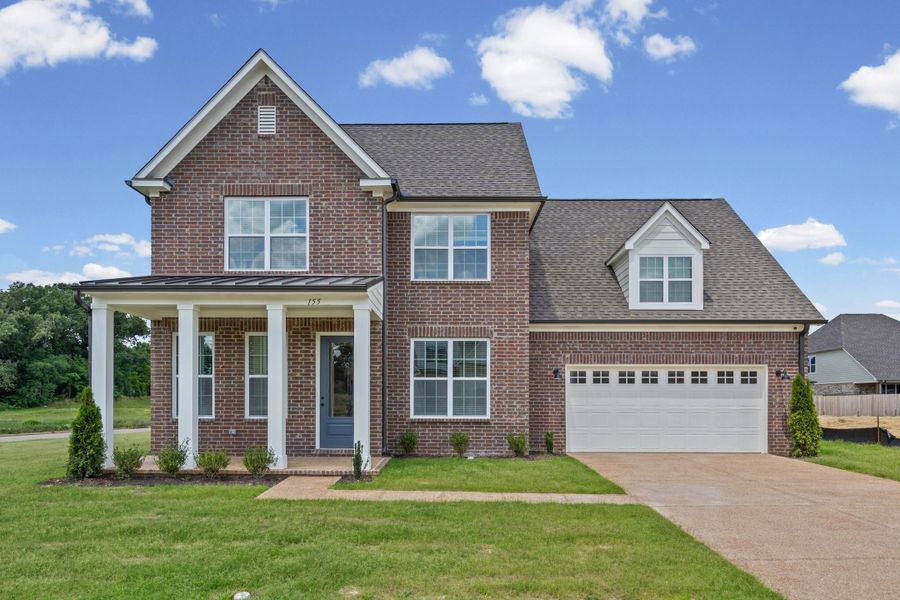 Two-story brick exterior with a front porch entry and white columns Two-story brick exterior with a front porch entry and white columns