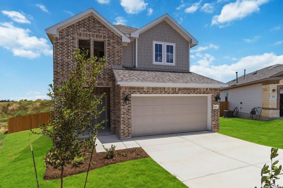 Front exterior of a new home in Hickory Ridge, Elmendorf, TX, highlighting curb appeal (Image 2). Front exterior of a new home in Hickory Ridge, Elmendorf, TX, highlighting curb appeal (Image 2).