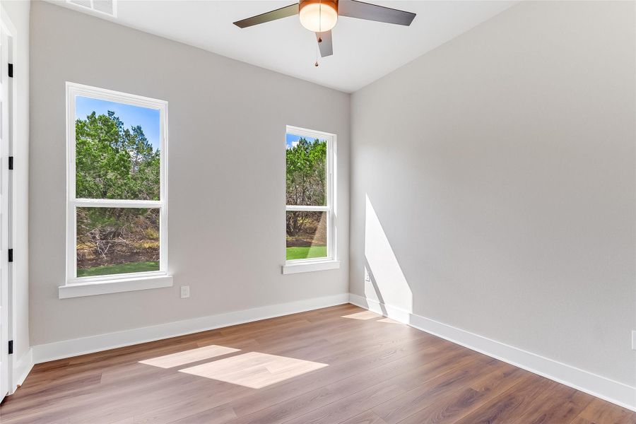 Unfurnished room featuring ceiling fan and wood finished floors
