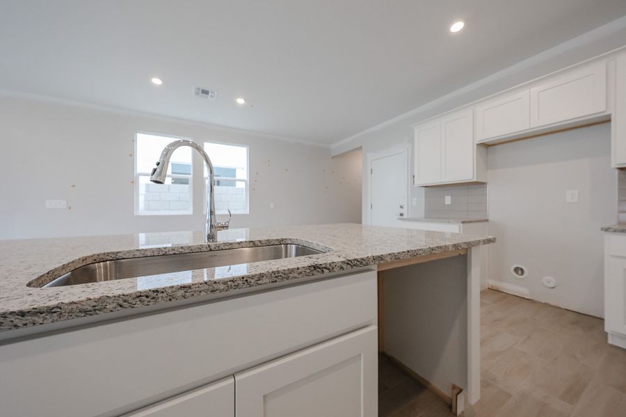 A kitchen with marble counters. A kitchen with marble counters.