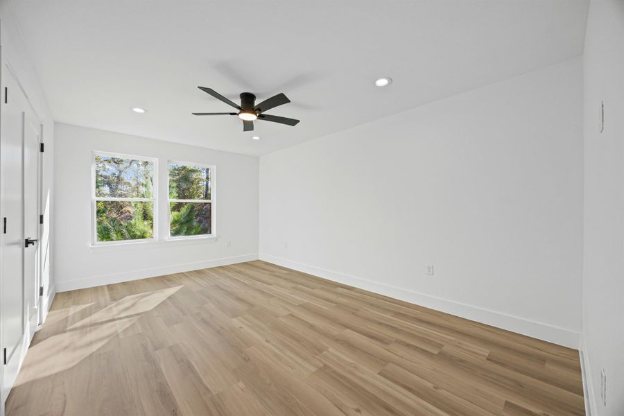 Secondary bedroom featuring light wood-type flooring, recessed lighting, and a ceiling fan