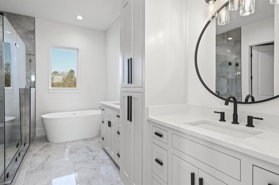 Full bath featuring a freestanding tub, a shower stall, marble finish floor, and vanity Full bath featuring a freestanding tub, a shower stall, marble finish floor, and vanity
