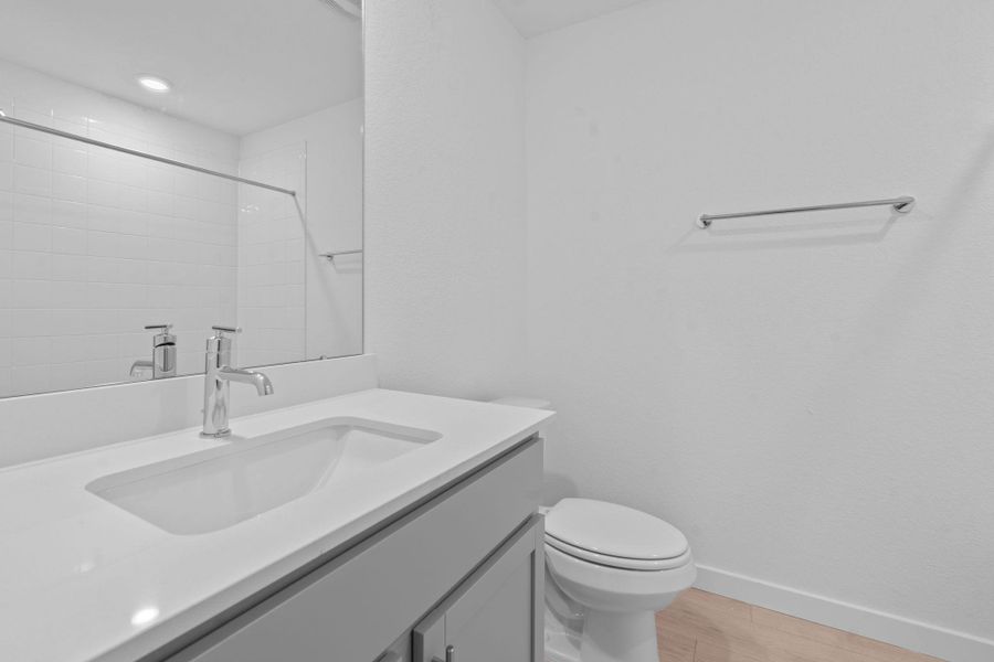 Bathroom with vanity, light wood finished floors, and tiled shower Bathroom with vanity, light wood finished floors, and tiled shower