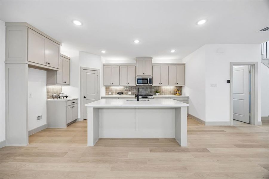The large kitchen island is the hub of your new dream kitchen!