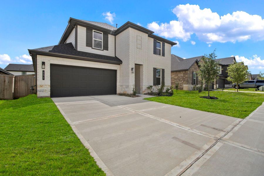 Front exterior of a new home in Hills of Westlake, Conroe, TX, highlighting curb appeal (Image 2). Front exterior of a new home in Hills of Westlake, Conroe, TX, highlighting curb appeal (Image 2).