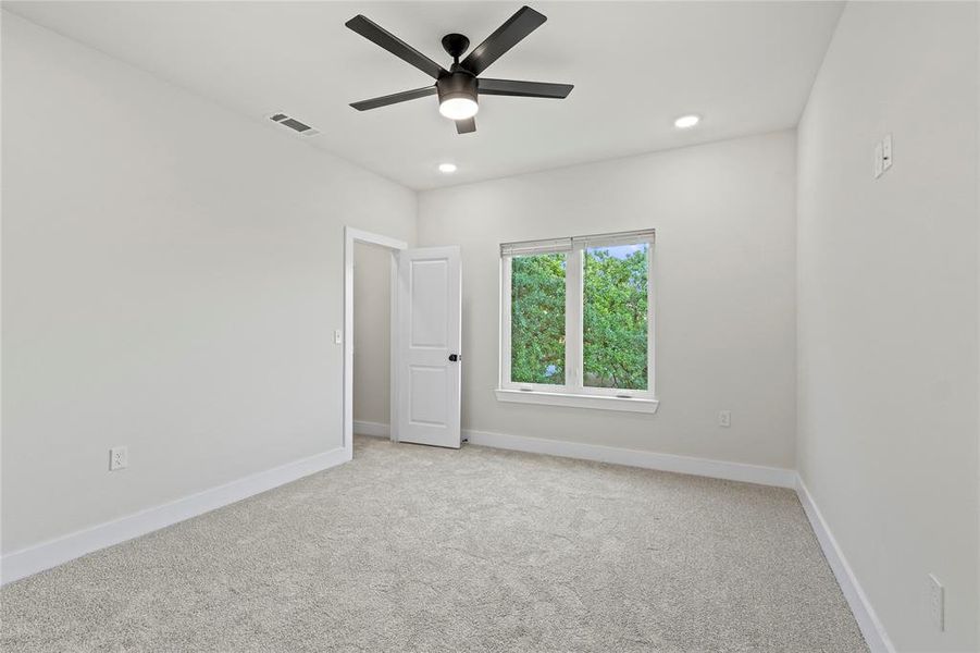 Empty room featuring light carpet, ceiling fan, and recessed lighting Empty room featuring light carpet, ceiling fan, and recessed lighting