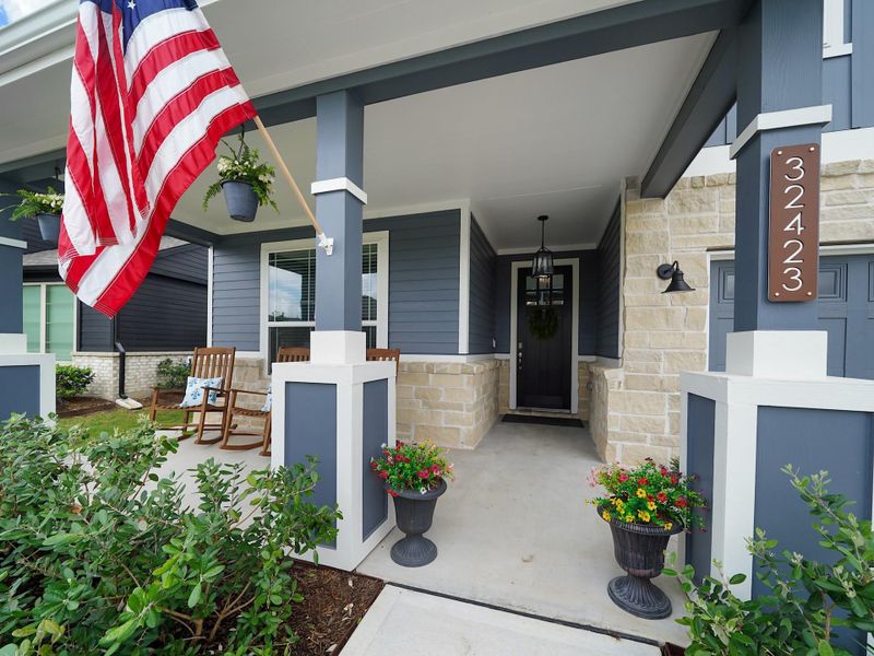 A welcoming front porch sets the tone, offering a charming space to enjoy morning coffee or unwind in the evenings while taking in the neighborhood setting.