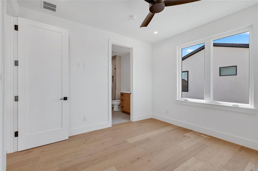 Unfurnished bedroom featuring light wood-style floors, ensuite bathroom, recessed lighting, and ceiling fan Unfurnished bedroom featuring light wood-style floors, ensuite bathroom, recessed lighting, and ceiling fan