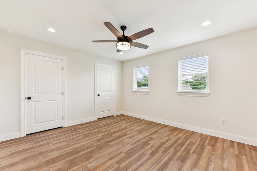Unfurnished room featuring recessed lighting, baseboards, and light wood-type flooring Unfurnished room featuring recessed lighting, baseboards, and light wood-type flooring