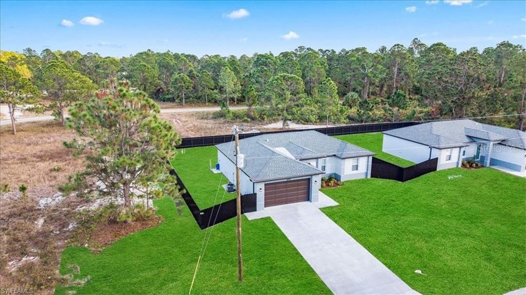 Front exterior of a new home in , Lehigh Acres, FL, highlighting curb appeal (Image 24).