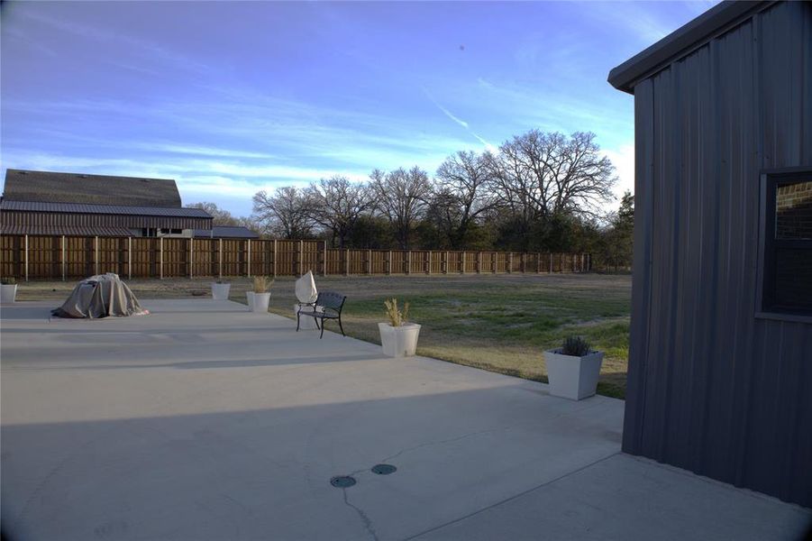 New Addition - Fenced backyard with a patio area