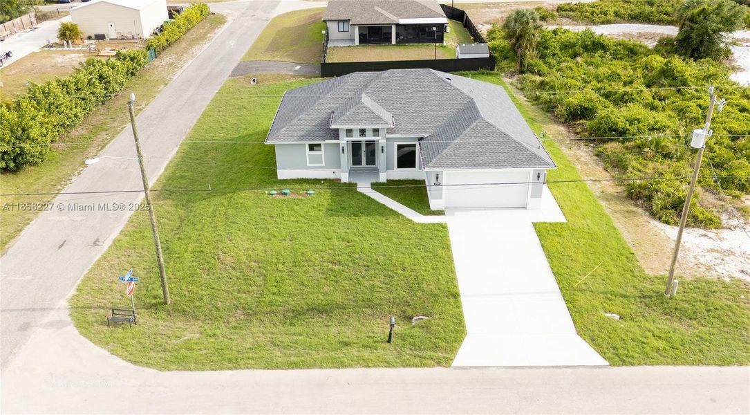 Front exterior of a new home in , Lehigh Acres, FL, highlighting curb appeal (Image 20).