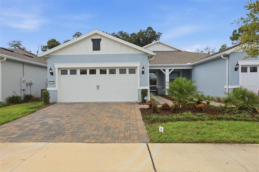 Front exterior of a new home in Del Webb Oasis, Winter Garden, FL, highlighting curb appeal (Image 22). Front exterior of a new home in Del Webb Oasis, Winter Garden, FL, highlighting curb appeal (Image 22).