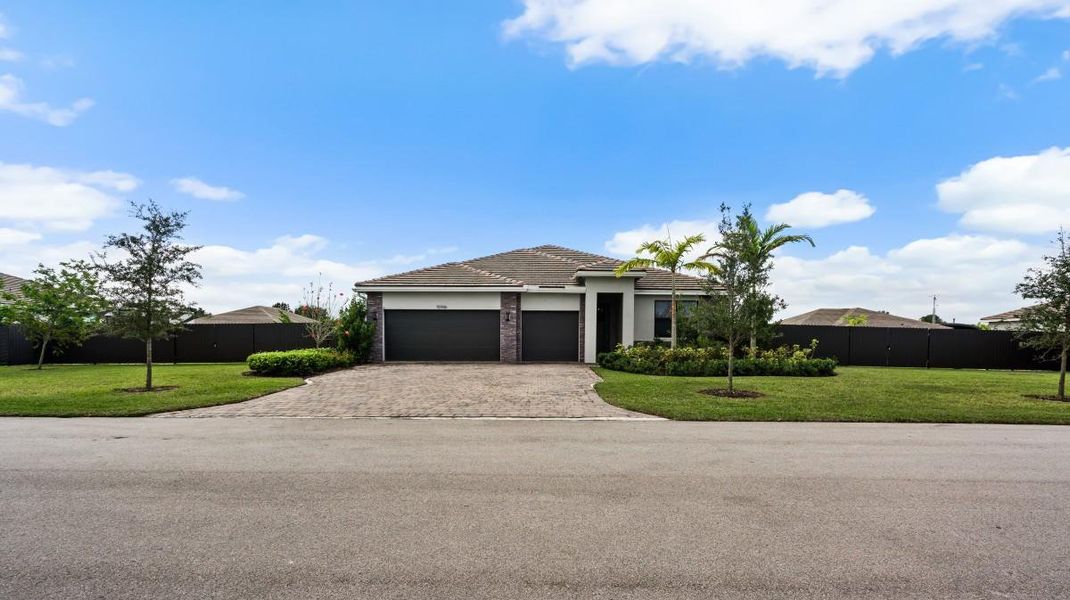 Front exterior of a new home in , Homestead, FL, highlighting curb appeal (Image 2). Front exterior of a new home in , Homestead, FL, highlighting curb appeal (Image 2).