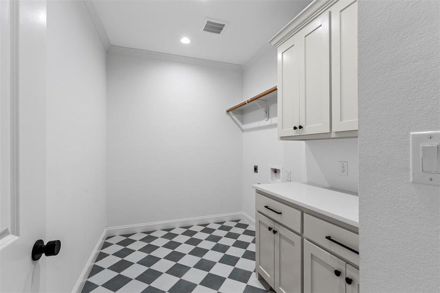 Washroom featuring light flooring, crown molding, washer hookup, cabinet space, and recessed lighting Washroom featuring light flooring, crown molding, washer hookup, cabinet space, and recessed lighting