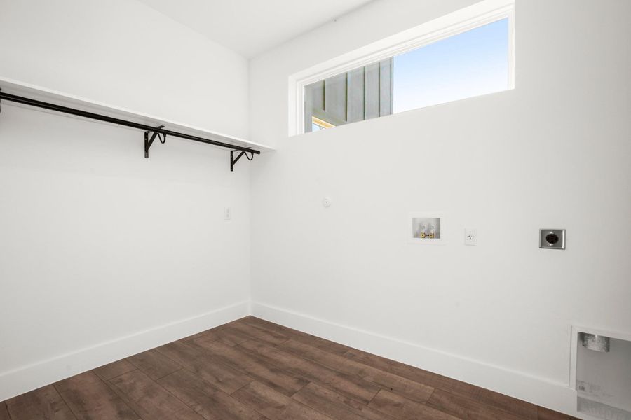 Laundry room featuring hookup for an electric dryer, hookup for a washing machine, and dark wood finished floors