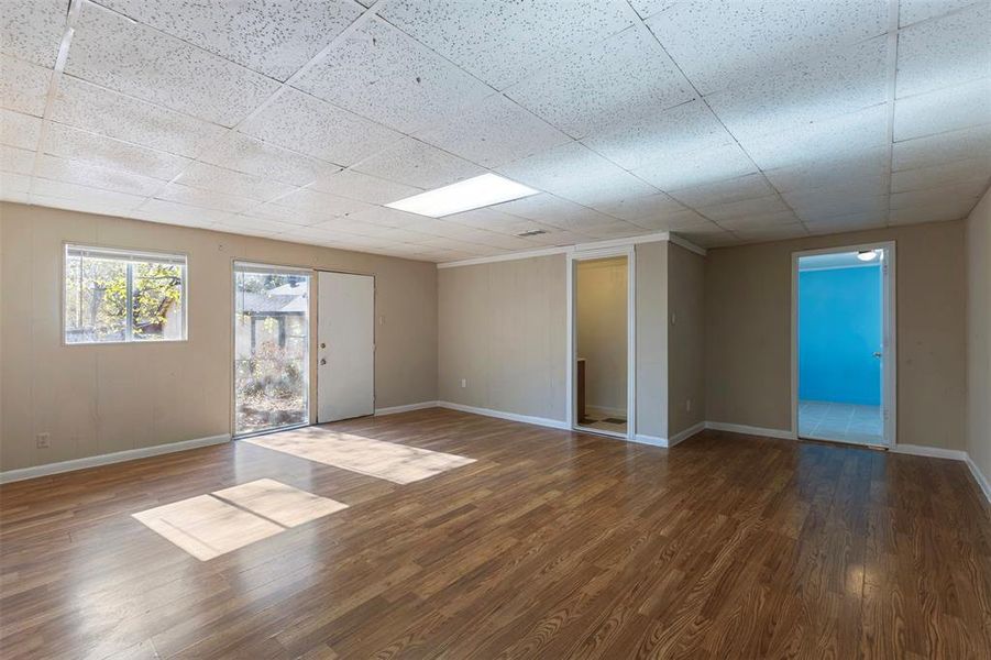 Empty room featuring wood finished floors and baseboards Empty room featuring wood finished floors and baseboards