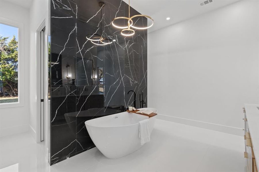 Bathroom featuring tile patterned floors and a tub