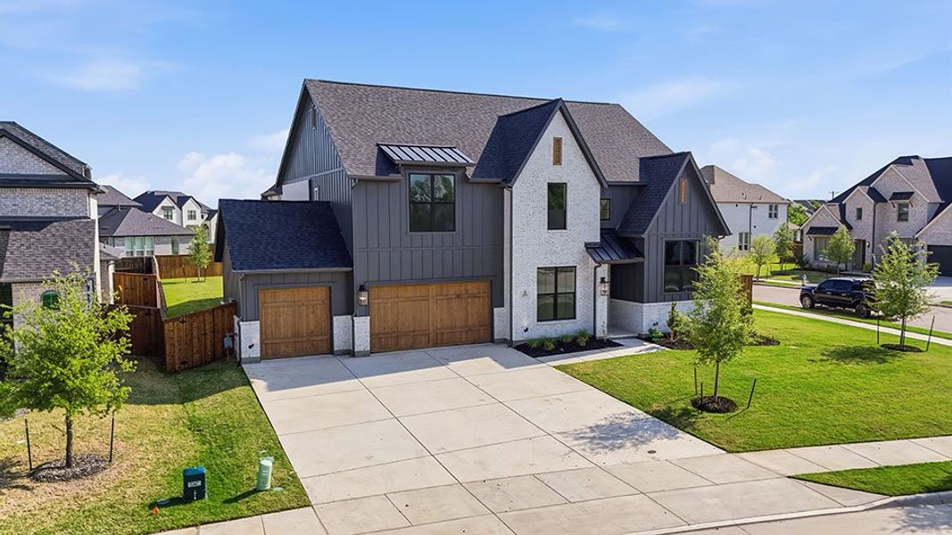 Front exterior of a new home in Light Farms Graham/Reagan, Celina, TX, highlighting curb appeal (Image 26).