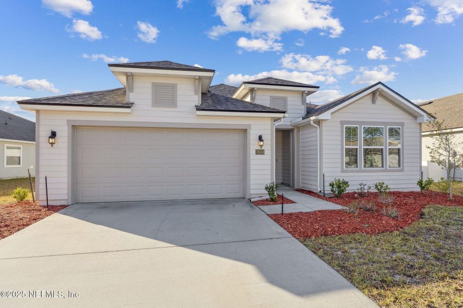Front exterior of a new home in River Glen, Yulee, FL, highlighting curb appeal (Image 23). Front exterior of a new home in River Glen, Yulee, FL, highlighting curb appeal (Image 23).