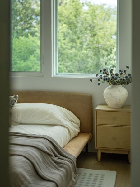 Natural light pours into this peaceful bedroom, creating a calm and inviting atmosphere.