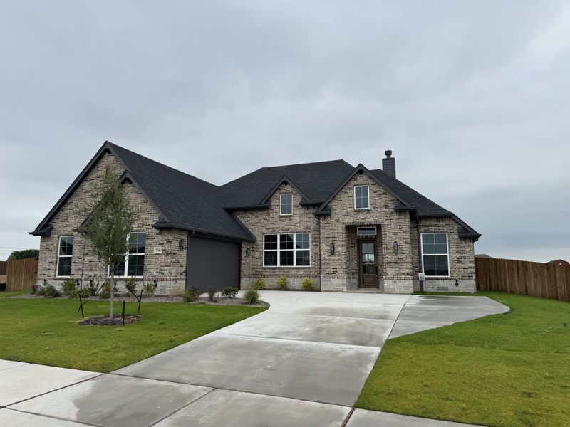 Front exterior of a new home in Coyote Crossing, Godley, TX, highlighting curb appeal (Image 2). Front exterior of a new home in Coyote Crossing, Godley, TX, highlighting curb appeal (Image 2).