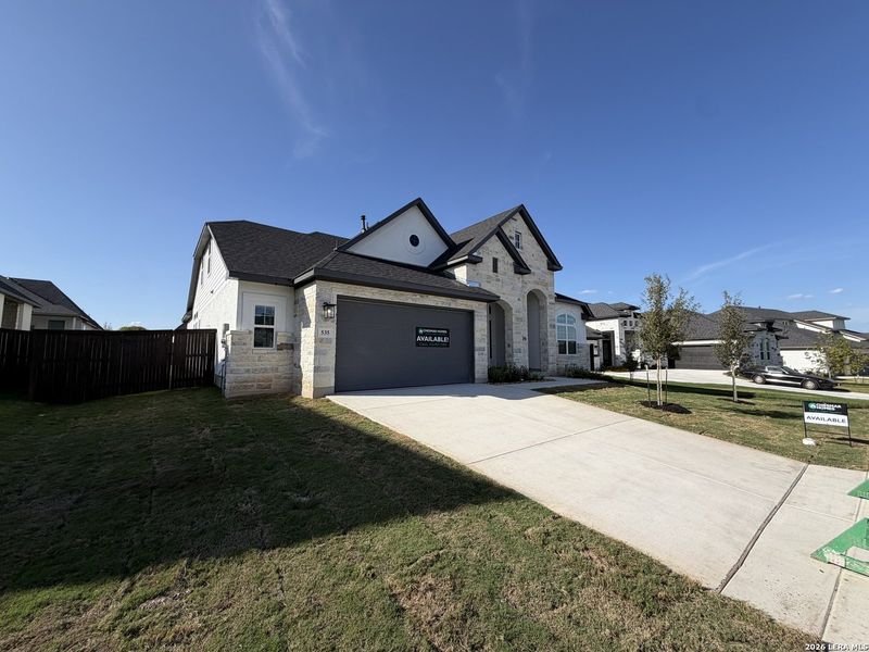 Front exterior of a new home in Mesa Western, Cibolo, TX, highlighting curb appeal (Image 2). Front exterior of a new home in Mesa Western, Cibolo, TX, highlighting curb appeal (Image 2).