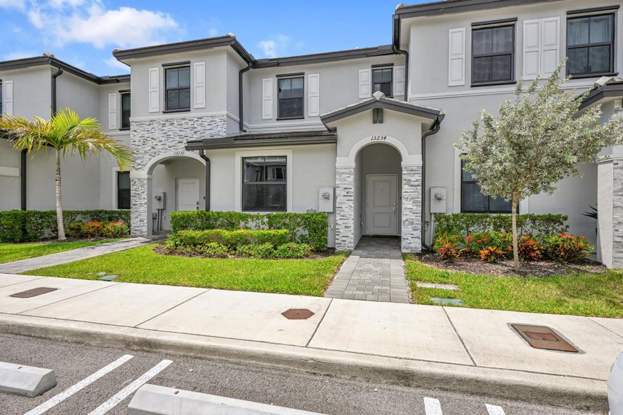 Front exterior of a new home in , Homestead, FL, highlighting curb appeal (Image 27). Front exterior of a new home in , Homestead, FL, highlighting curb appeal (Image 27).