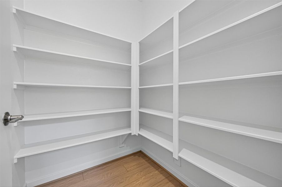 The spacious walk-in pantry offers abundant shelving, providing the perfect spot to keep your kitchen essentials neatly organized and easily accessible. The spacious walk-in pantry offers abundant shelving, providing the perfect spot to keep your kitchen essentials neatly organized and easily accessible.