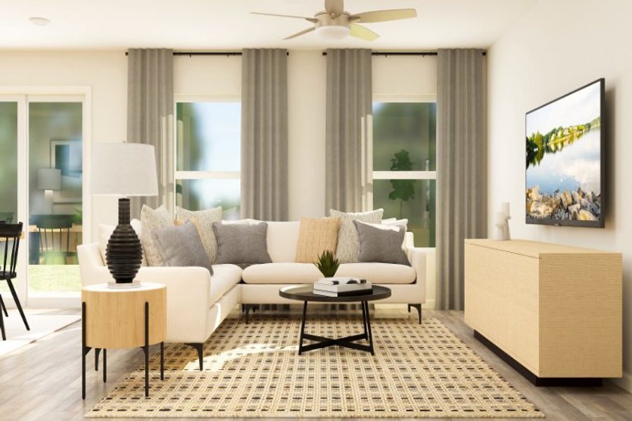 A living room with a white couch and a table.