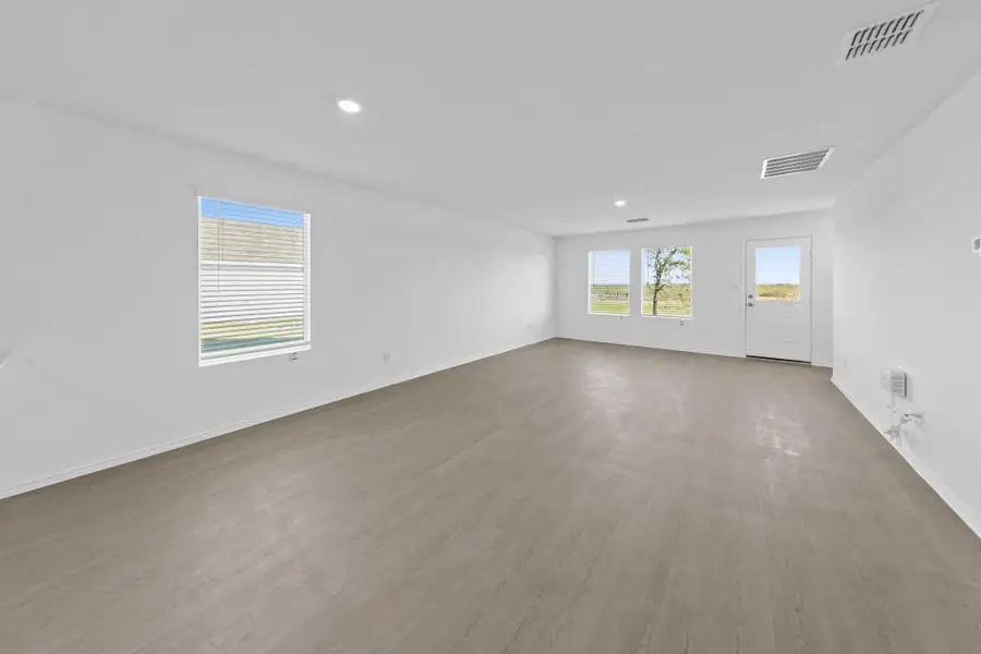 Spare room with light wood-type flooring and recessed lighting