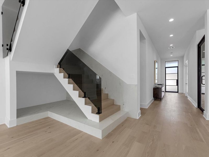 Upon entry, you are greeted by the formal foyer and wide oak flooring.