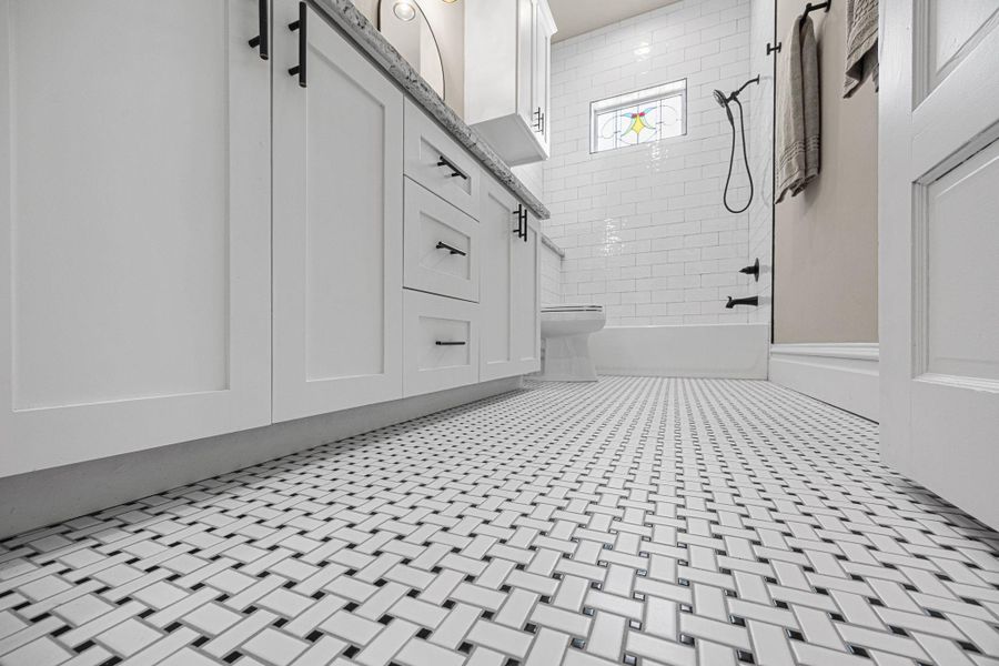 The bathroom flooring adds a dose of vintage charm in this space. The bathroom flooring adds a dose of vintage charm in this space.