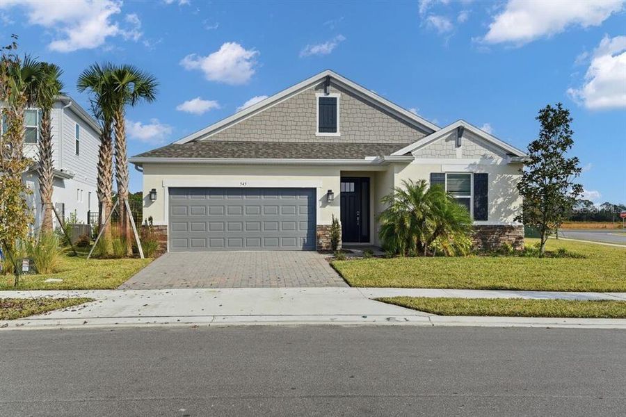 Front exterior of a new home in Ardisia Park, New Smyrna Beach, FL, highlighting curb appeal (Image 29). Front exterior of a new home in Ardisia Park, New Smyrna Beach, FL, highlighting curb appeal (Image 29).