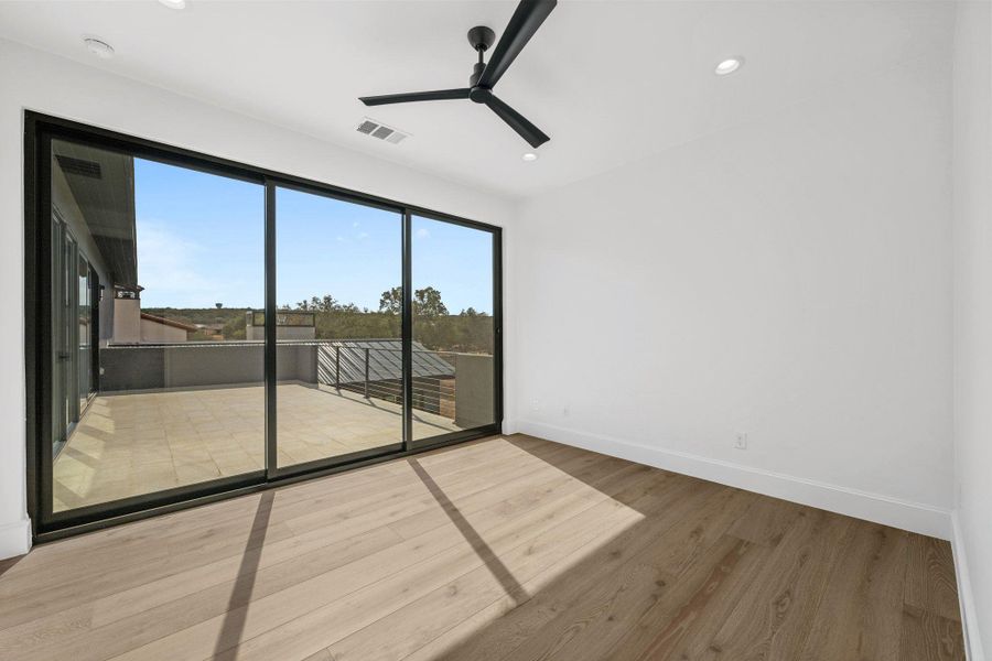 Spare room with a ceiling fan, wood finished floors, and recessed lighting