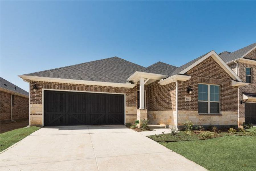 Front exterior of a new home in Spiritas Ranch, Little Elm, TX, highlighting curb appeal (Image 17).