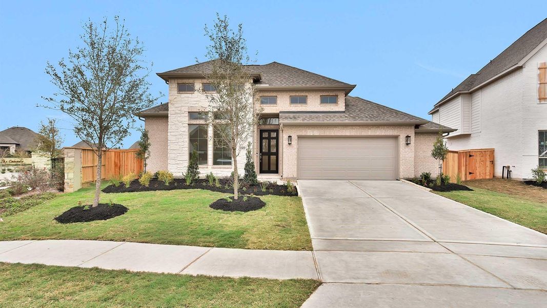 Front exterior of a new home in Meridiana, Manvel, TX, highlighting curb appeal (Image 2). Front exterior of a new home in Meridiana, Manvel, TX, highlighting curb appeal (Image 2).