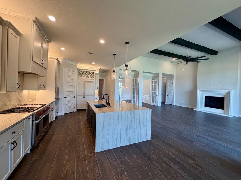 Gleaming wood-look floors anchor this airy open concept kitchen and adjoining living area.
