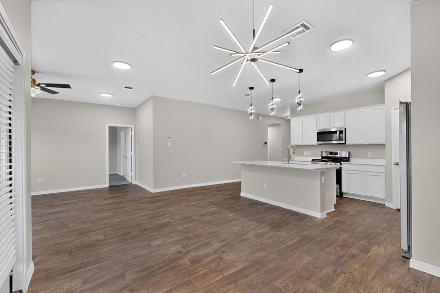 A spacious open-plan layout connects the main living area with a modern kitchen.